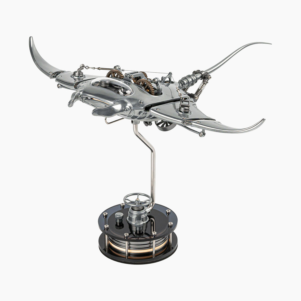 Mecha Ray Natural Metal — unpainted manta with wings spread and the gear train open to view, on a weighted drive base, kinetic sculpture by IFL Watches.