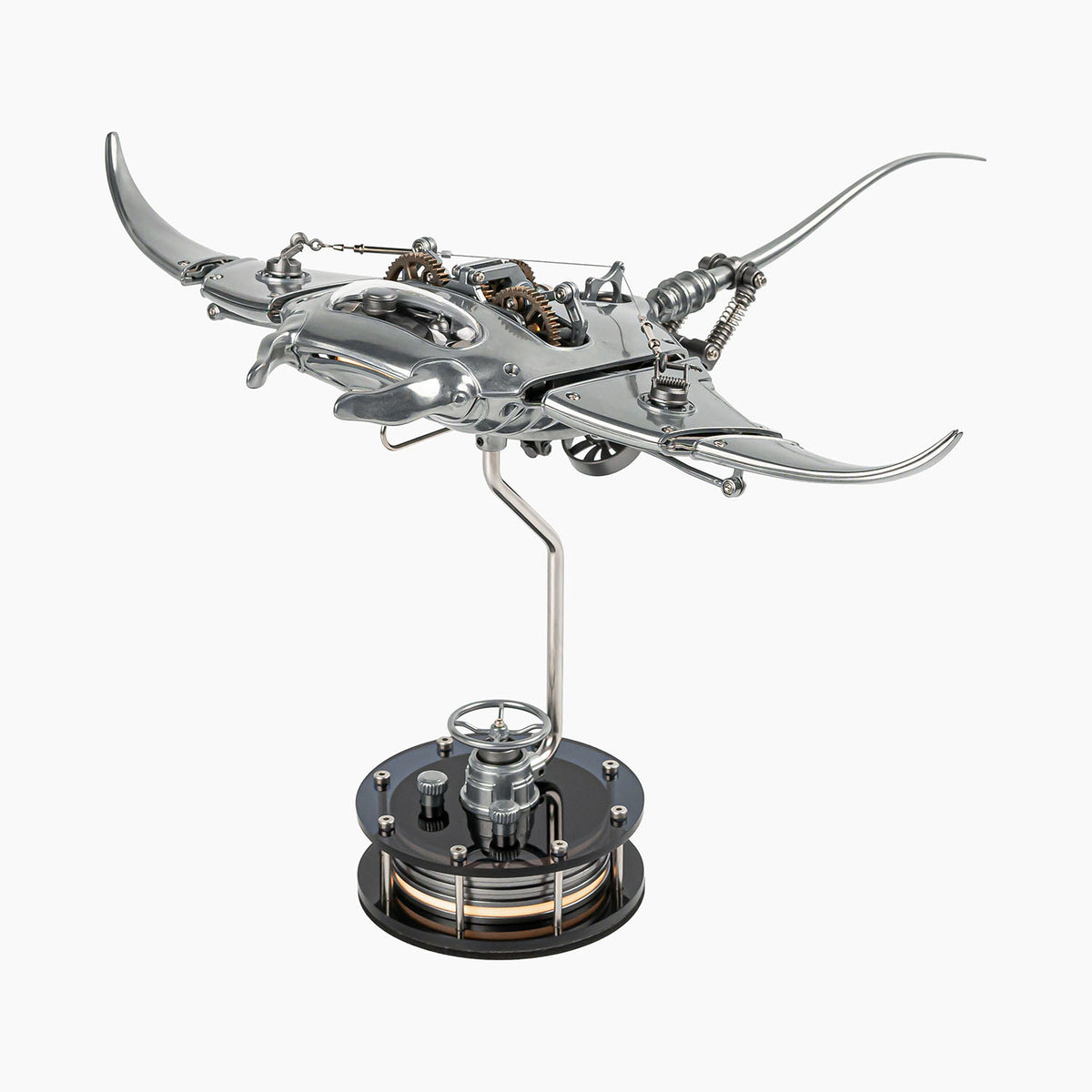 Mecha Ray Natural Metal — unpainted manta with wings spread and the gear train open to view, on a weighted drive base, kinetic sculpture by IFL Watches.