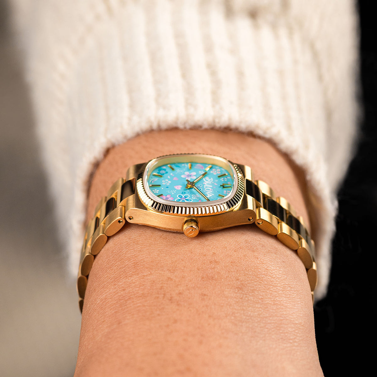 Bulova Super Seville Jardin Bleu — Side profile showing the coin-edge bezel, crown and polished gold links, with the custom hand-painted floral dial in view, a bespoke timepiece by IFL Watches.