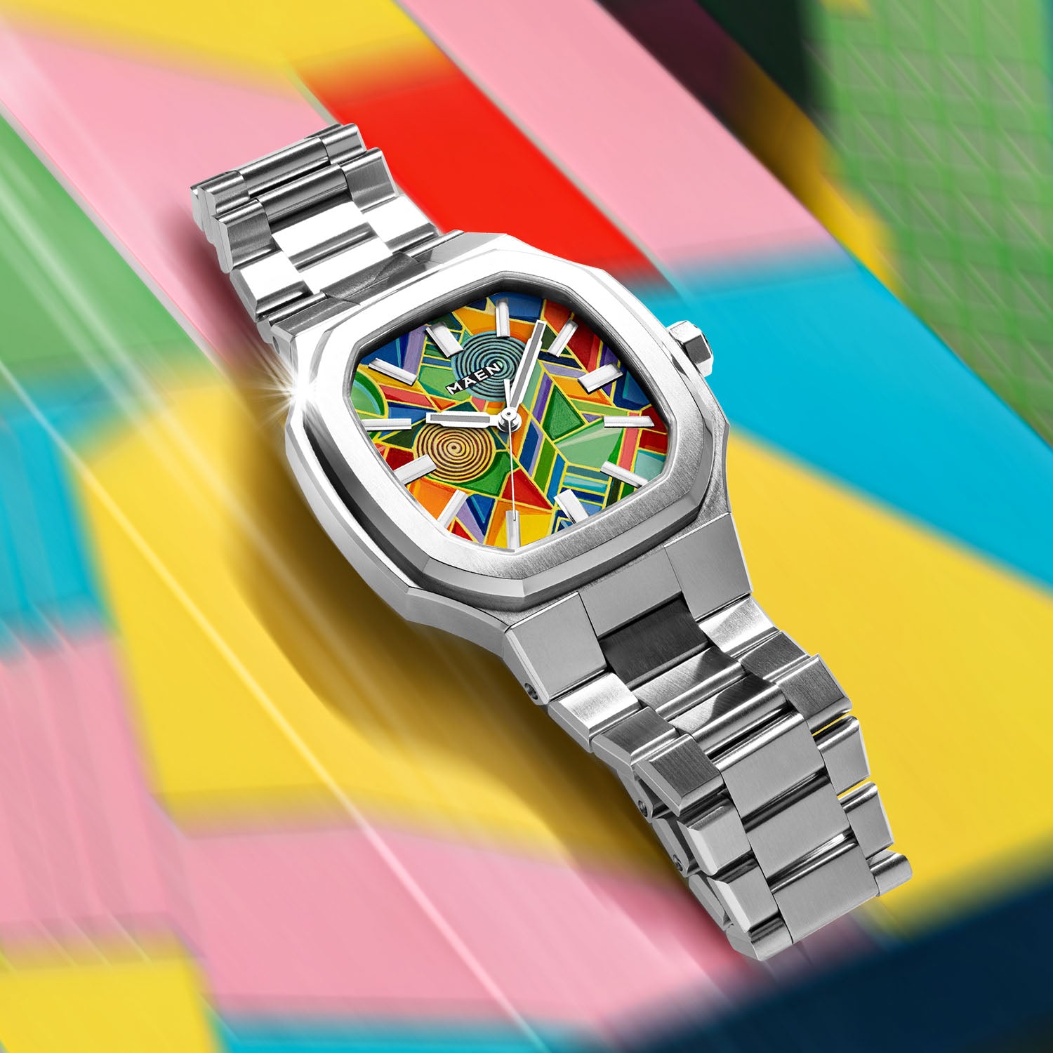 MAEN Manhattan Paradox — hand-painted geometric color-block dial with chevrons, mesh, and two concentric disks on a 37mm octagonal stainless steel case with integrated bracelet, limited edition timepiece by IFL Watches.