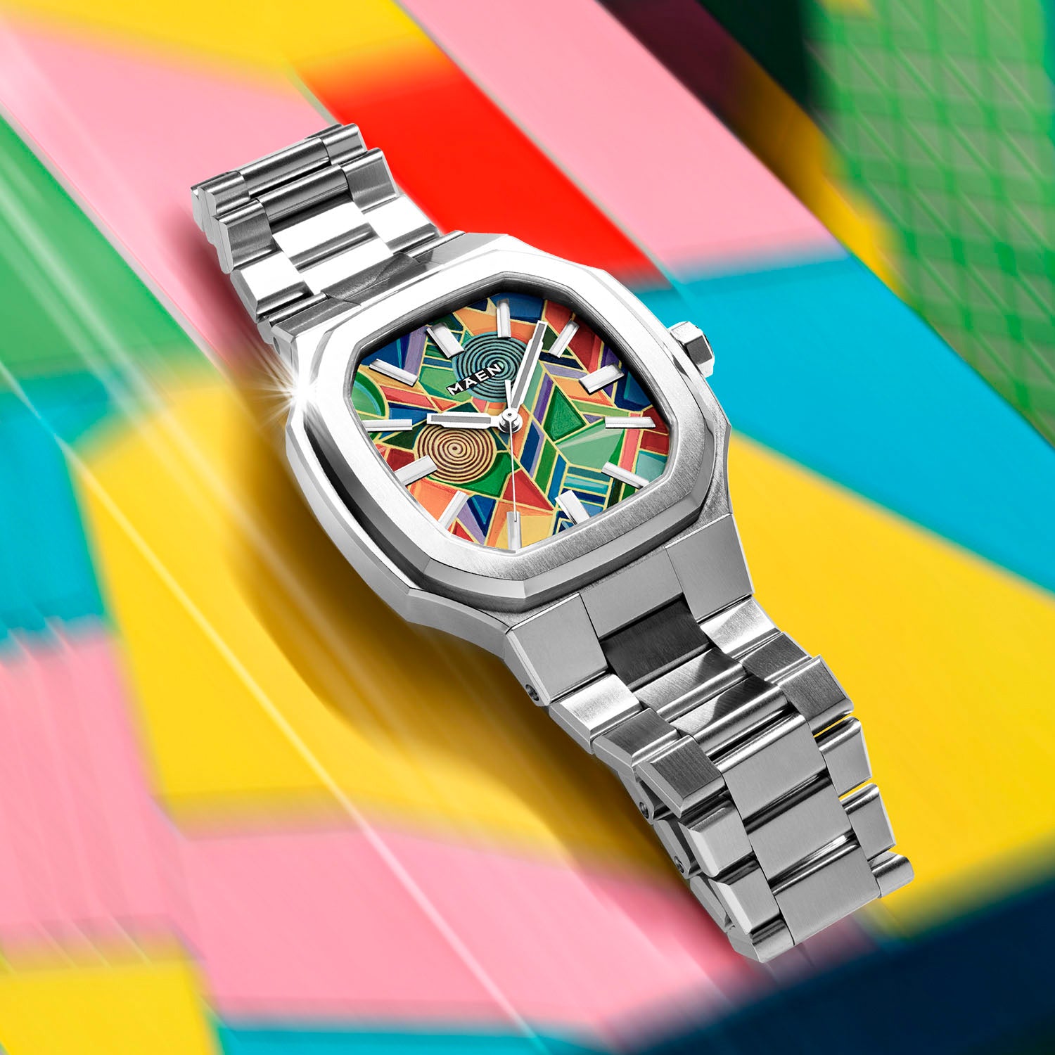MAEN Manhattan Paradox — hand-painted geometric color-block dial with chevrons, mesh, and two concentric disks on a 37mm octagonal stainless steel case with integrated bracelet, limited edition timepiece by IFL Watches.