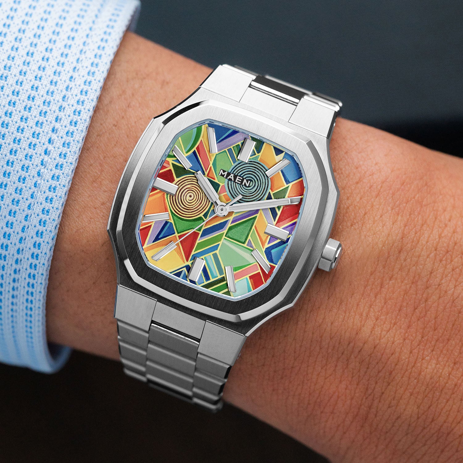 MAEN Manhattan Paradox — hand-painted geometric color-block dial with chevrons, mesh, and two concentric disks on a 37mm octagonal stainless steel case with integrated bracelet, limited edition timepiece by IFL Watches.