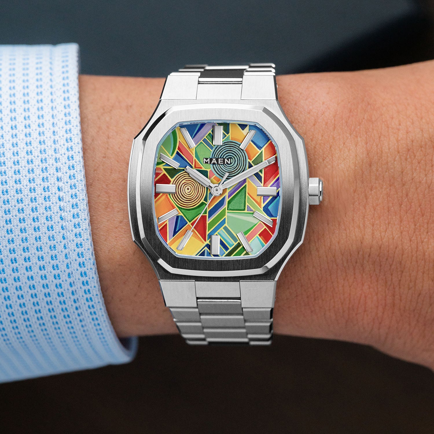 MAEN Manhattan Paradox — hand-painted geometric color-block dial with chevrons, mesh, and two concentric disks on a 37mm octagonal stainless steel case with integrated bracelet, limited edition timepiece by IFL Watches.