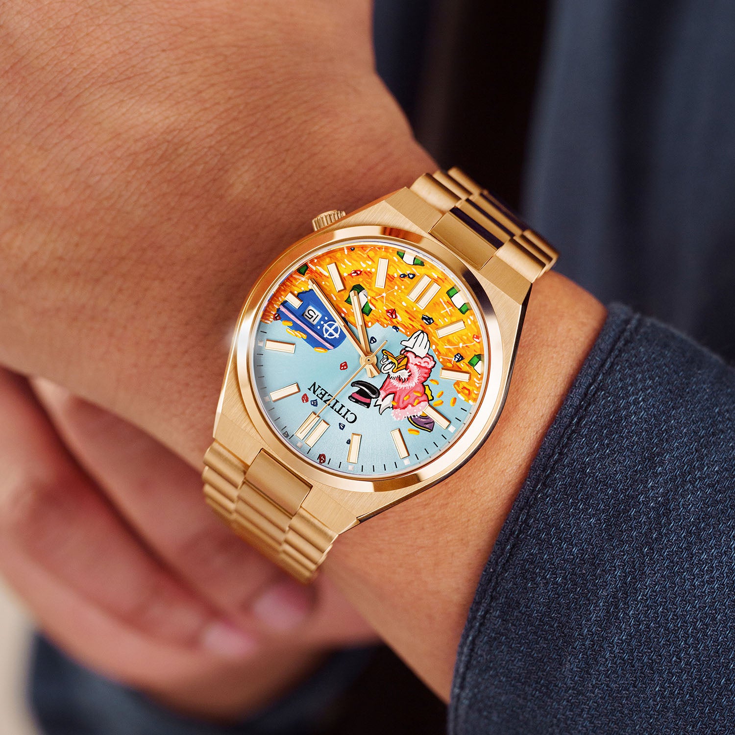 Citizen Tsuyosa Dive in Time on wrist — angled view capturing the hand-painted golden treasure scene with banknotes and coins across the dial, rose gold case catching the light, a bespoke timepiece by IFL Watches.