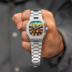MAEN Manhattan Memento — Held up in a closed hand, the 37mm octagonal steel watch shows its hand-painted custom dial of draped soft watches under a sky fading from deep blue to yellow, on its integrated bracelet, a bespoke timepiece by IFL Watches.