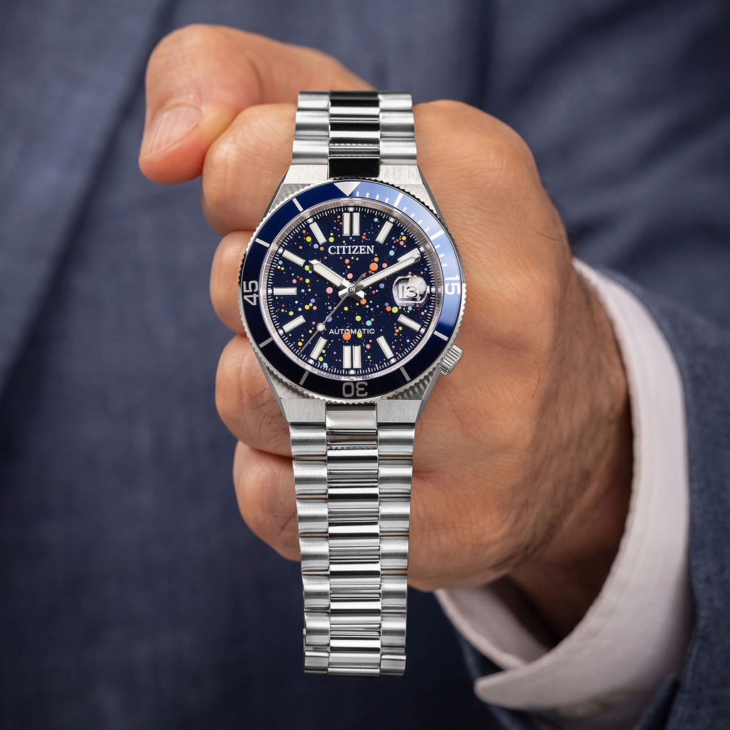 Citizen Tsuyosa Shore Midnight Sky held in hand — full view of the hand-painted pointillism dial and stainless steel bracelet, limited edition timepiece by IFL Watches.