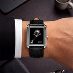Laphont Bloc Bouquella — Seen from above on the wrist, a white shirt cuff and dark sleeve framing the black croc-embossed strap and stepped steel case, a custom limited edition watch by IFL Watches
