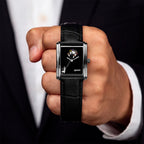 Laphont Bloc Bouquella — Held in a closed fist toward the camera, the hand-painted bouquets and the full length of the black croc-embossed strap in view, a limited edition bespoke timepiece by IFL Watches