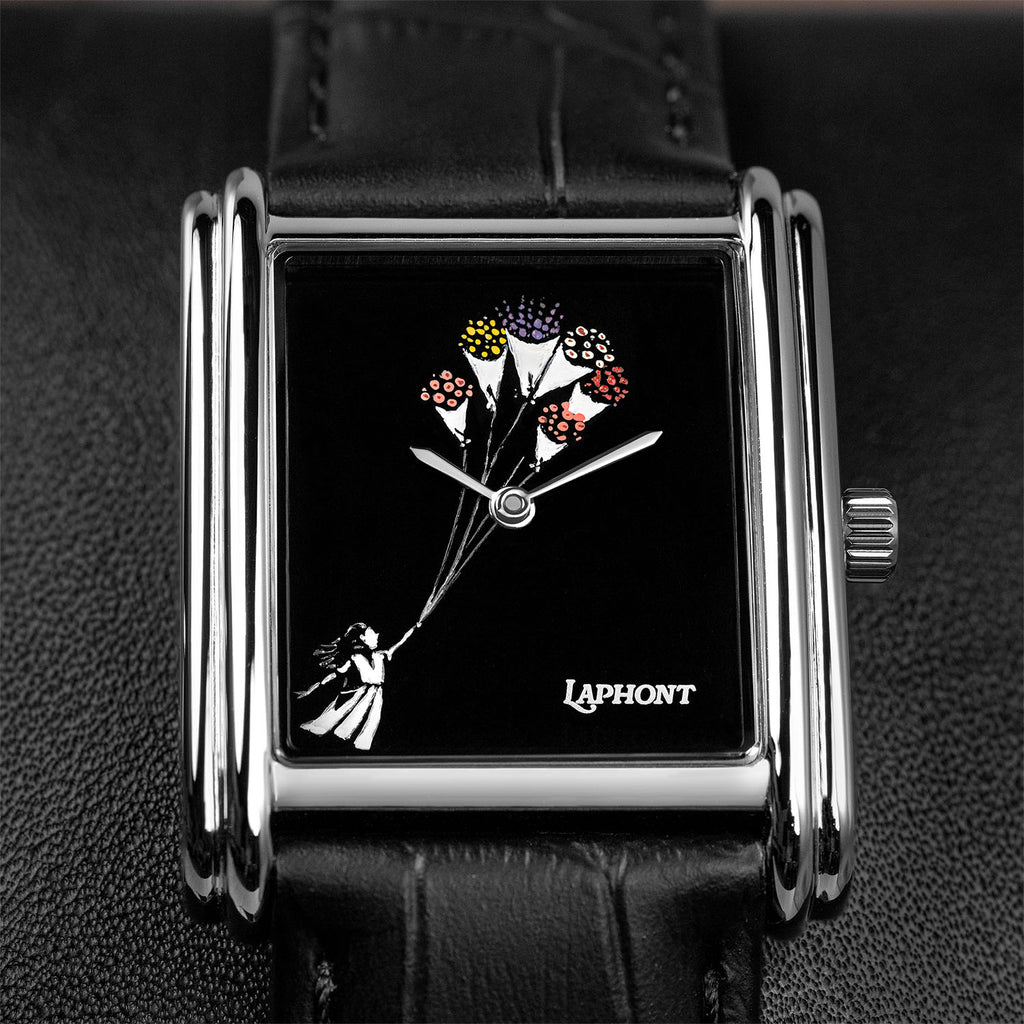Laphont Bloc Bouquella — Close-up of the hand-painted girl holding the strings of her bouquets, the hands turning at the centre of the glossy black dial inside the stepped steel case, a custom limited edition watch by IFL Watches