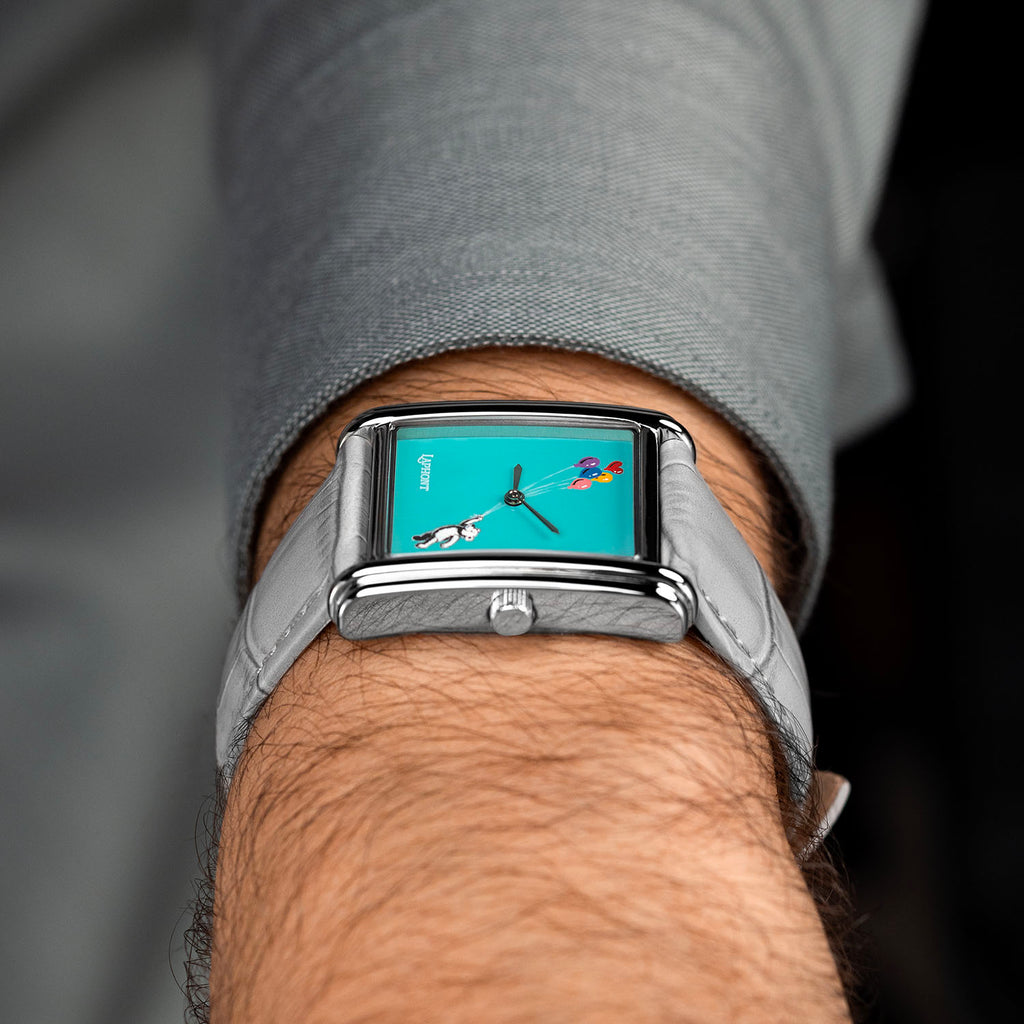 Laphont Bloc Cloudling — Side view on the wrist from the crown, the slim profile of the stepped steel case resting under a grey shirt cuff, a hand-painted limited edition watch by IFL Watches