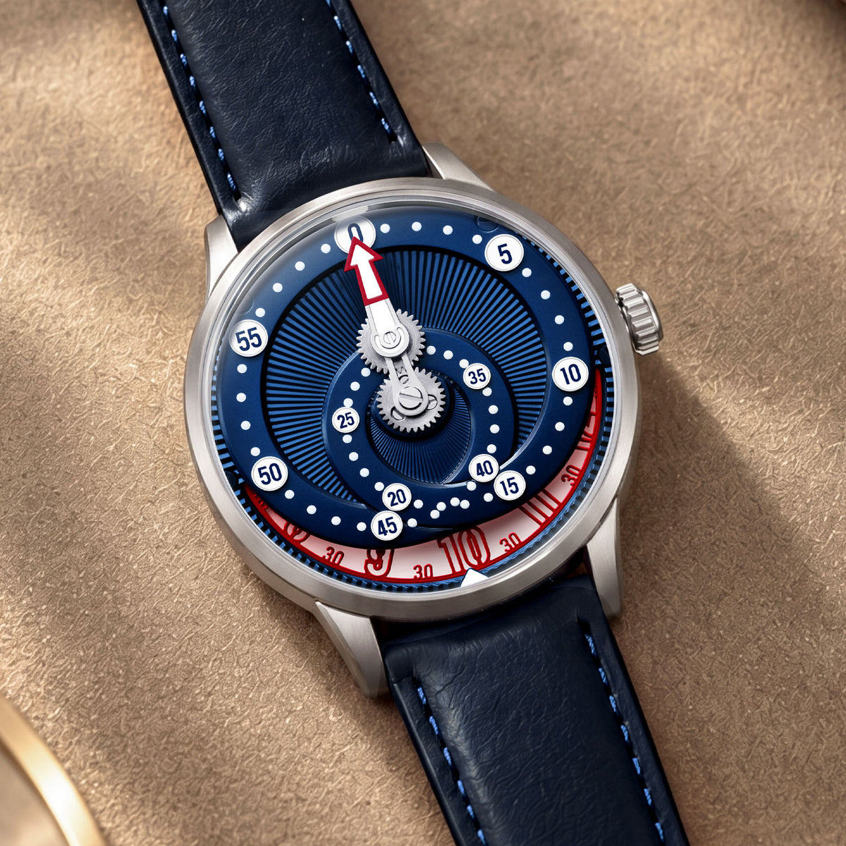 Mandetbrote Orbital Blue Kiss — Resting on beige suede, showing the red-and-white hour disc, available at IFL Watches.