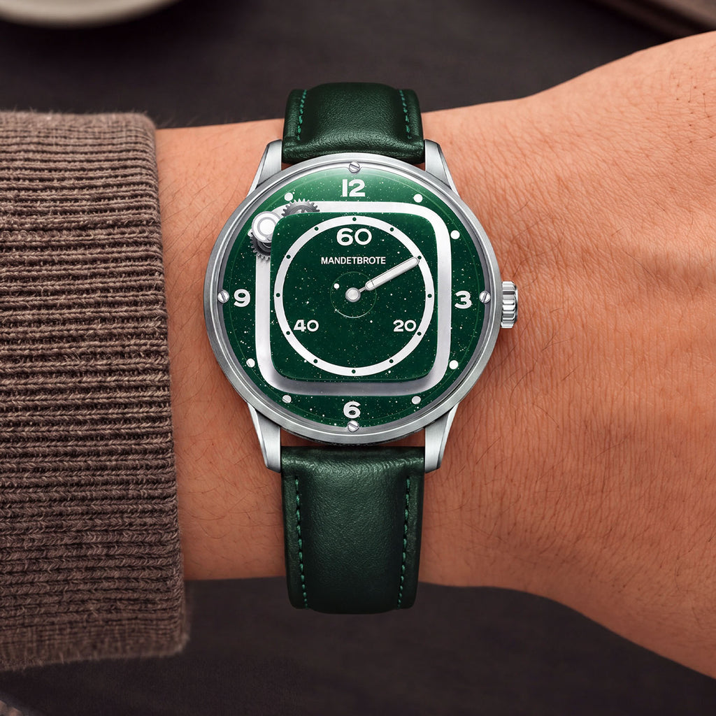 Mandetbrote Orbital II Green — Worn on wrist with a brown cuff, showing the hour rail and minute display, available at IFL Watches.
