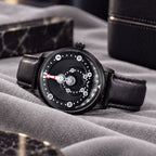 Mandetbrote Orbital Midnight Black — Lying on grey fabric beside a marble block, seen in three-quarter view, available at IFL Watches.