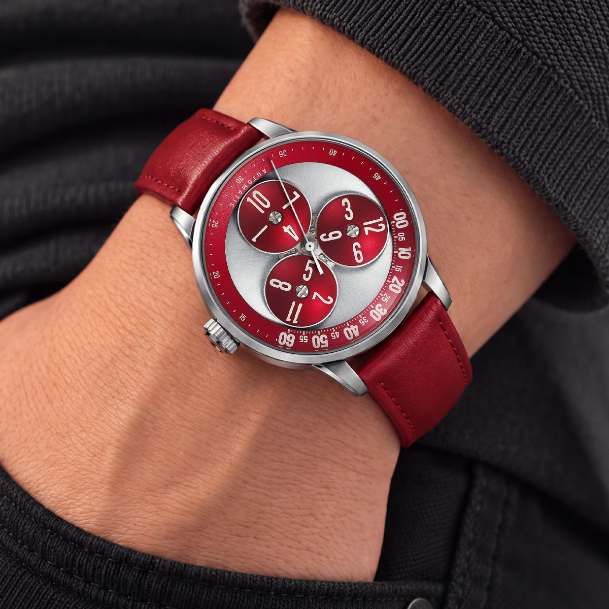 Mandetbrote Wandering Hour Burgundy — Worn on wrist with a hand in pocket, seen from a relaxed angle, available at IFL Watches.