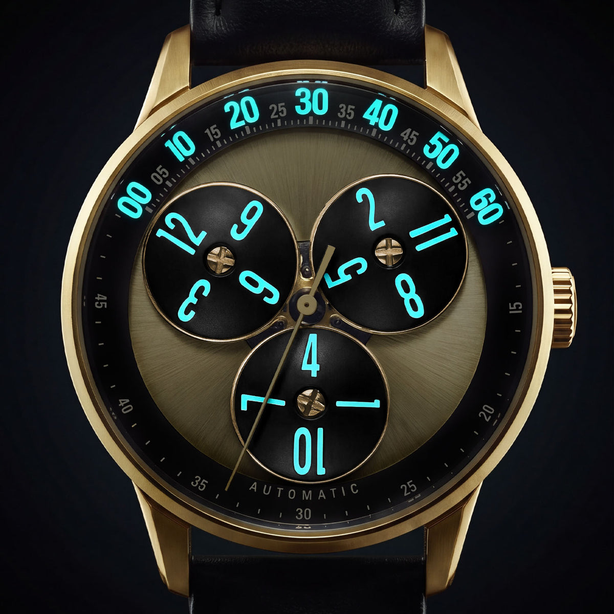 Mandetbrote Wandering Hour Gold — In the dark, with the hour numerals and minute track glowing, available at IFL Watches.