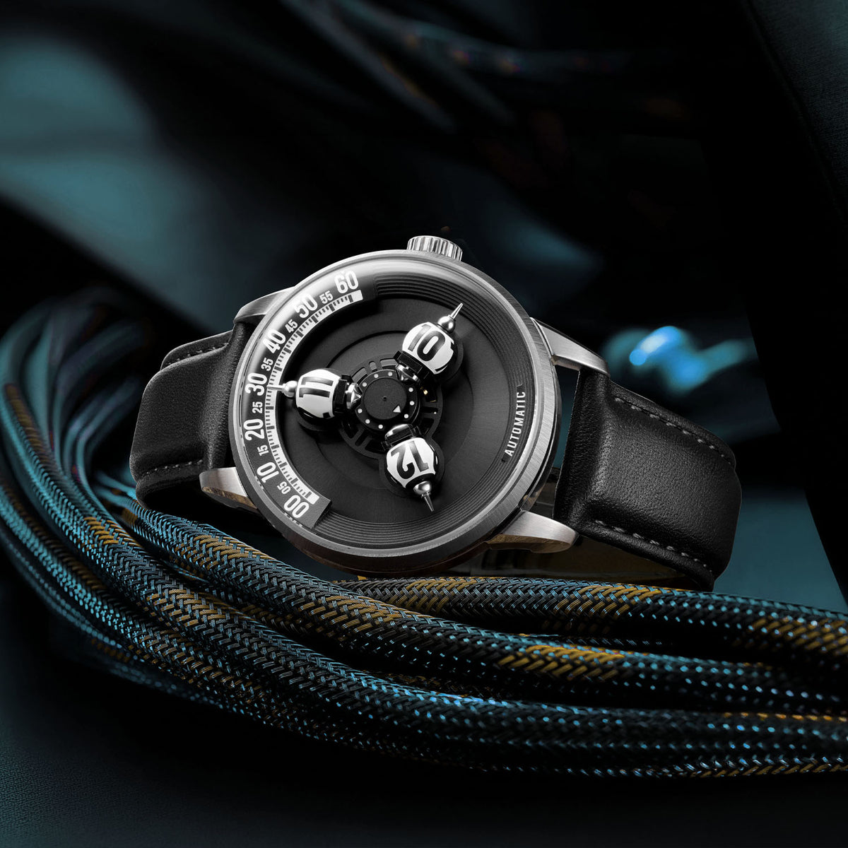 Vortichron Timeorb Midnight Black — Three-quarter view resting on braided cord in teal light, available at IFL Watches.