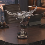 Mecha Ray Natural Metal — the bare-metal manta in motion on an executive desk against a night city view, with close-ups of the exposed gears, wing louvres and sprung linkage, mechanical sculpture by IFL Watches.